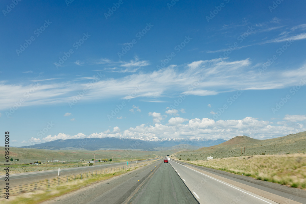Beautiful road on a sunny day. Highway in America among the mountains. Traveling on a beautiful road. Holiday trip