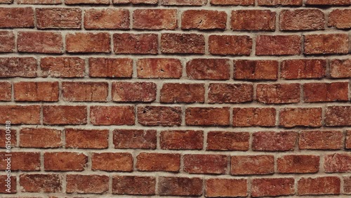 Dark brick walls are erected unevenly.