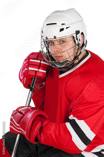 Male ice hockey player in helmet holding hockey stick on a white background