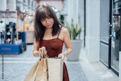 Happy young women looking into shopping bags at shoppingmall photo