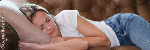 Sleeping lazy woman lies on couch during day