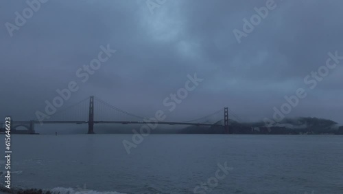 Golden Gate Bridge by Cloudy Misty Weather Early Fog Before Sunrise Sunshine photo