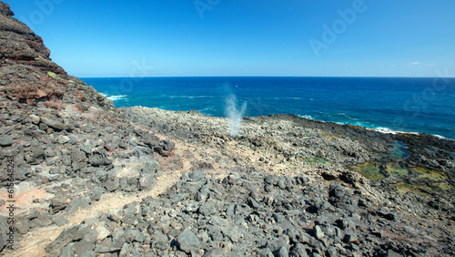 Makapuu hiking trail by the Dragons nostrils blowhole spewing seawater at the popular Makapuu tidepools on the north shore of Oahu Hawaii United States photo