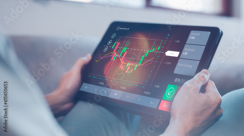 financial investment concept, businessman using computer tablet with virtual trading graph stock or cryptocurrency exchange in concept of investment business growth and marketing