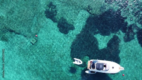 Yacht Boat anchored in Blue Lagoon of Veliki Budikovac Island floating on turquoise clear water, Croatia. Aerial photo