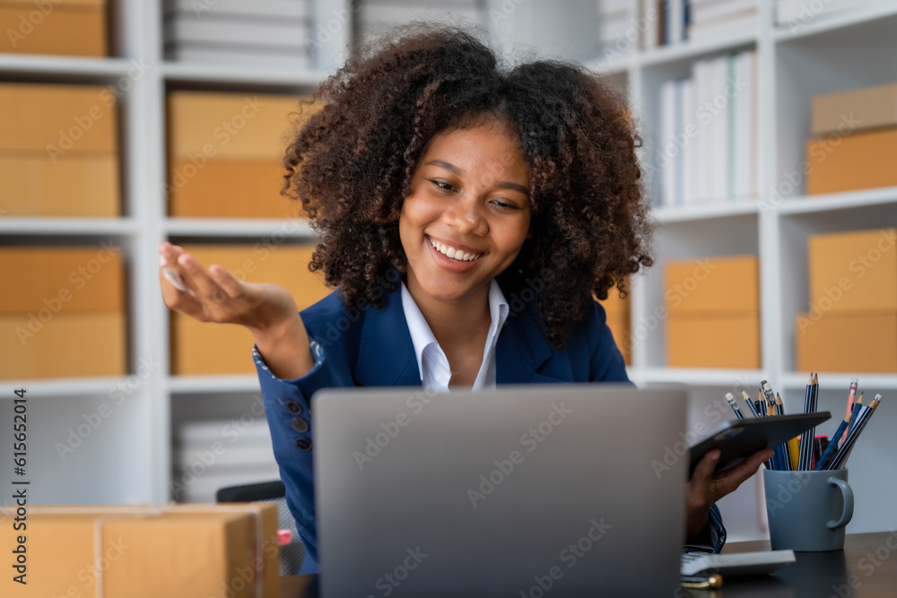 Pretty young african american woman startup freelancer business people is working at warehouse for online store. Pretty young african american woman startup freelancer business people is working at warehouse for online store.