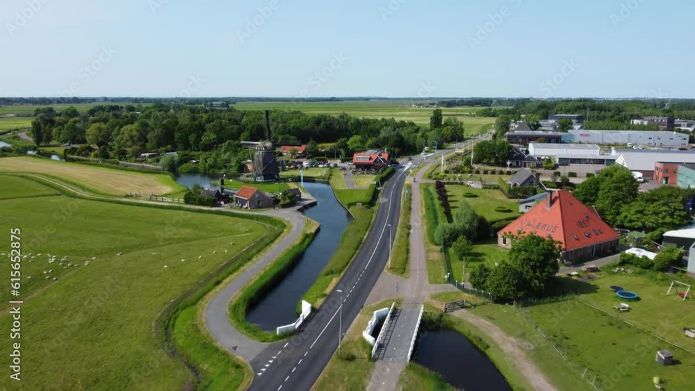 Establishing aerial view to traditional Dutch De Dog touristic windmill, Zaanse Schans small town paint mill Establishing aerial view to traditional Dutch De Dog touristic windmill, Zaanse Schans small town paint mill