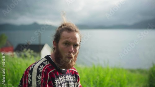 Bearded Man Eating Fresh Bush Vetch (Vicia sepium). - close up photo