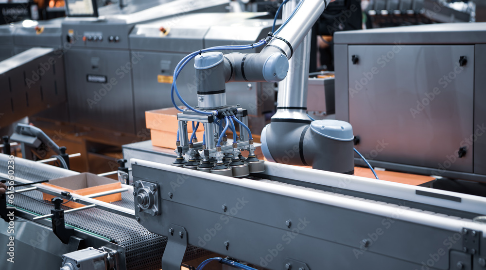 Automated robot arm lifting food can to conveyor belt in food industry. Automated robot arm lifting food can to conveyor belt in food industry.