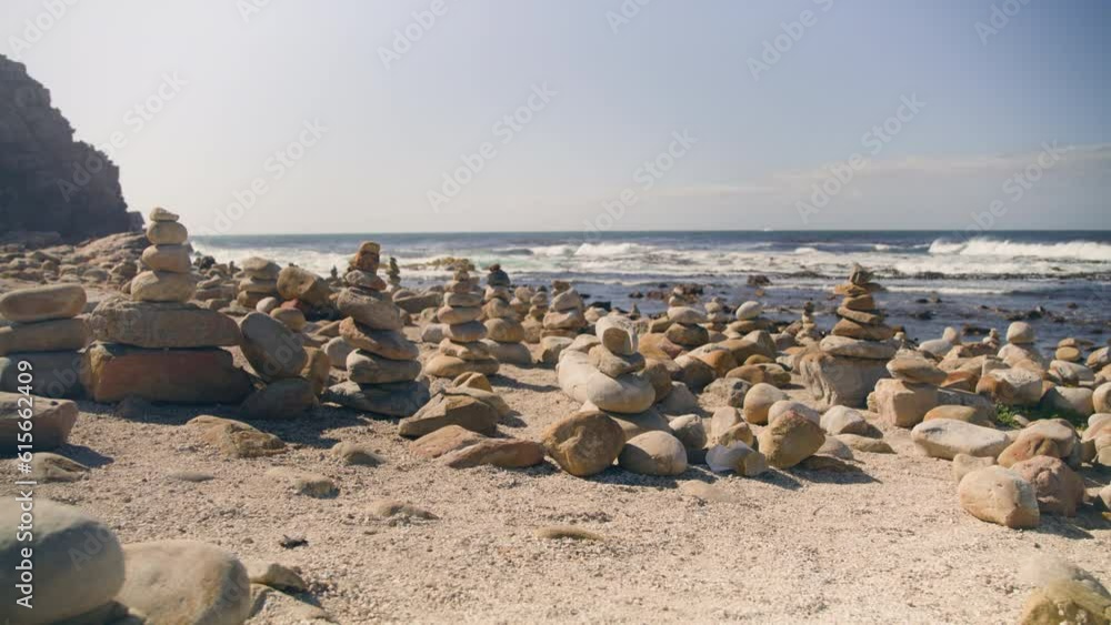 Pull out on multiple cairns at beach infront of ocean at cape point national park Pull out on multiple cairns at beach infront of ocean at cape point national park