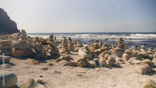Pull out on multiple cairns at beach infront of ocean at cape point national park