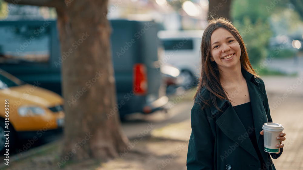 Fototapeta premium cheerful girl teenager with a paper cup of coffee
