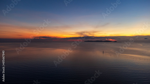 Sunrise sky over horizon in morning with colorful clouds. Orange sunlight.