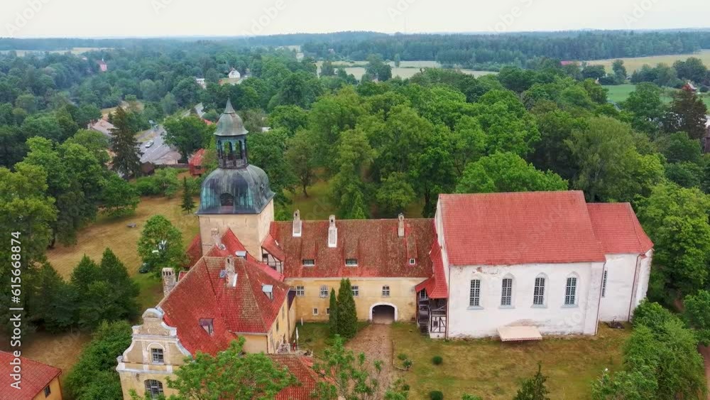 Lielstraupe Medieval Castle in the Village of Straupe in Vidzeme, in Northern Latvia. Aerial Dron Shot Lielstraupe Castle United in One Corps With the Church Surrounded by a Park With Pond. Rainy Day Lielstraupe Medieval Castle in the Village of Straupe in Vidzeme, in Northern Latvia. Aerial Dron Shot Lielstraupe Castle United in One Corps With the Church Surrounded by a Park With Pond. Rainy Day