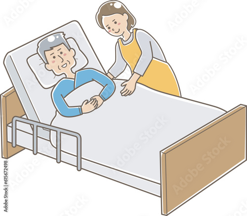 ベッドで寝ているお年寄りと介護スタッフ