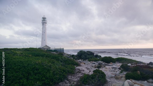 Slangkop lighthouse in Kommetjie at blue hour with ocean in background at the beach photo