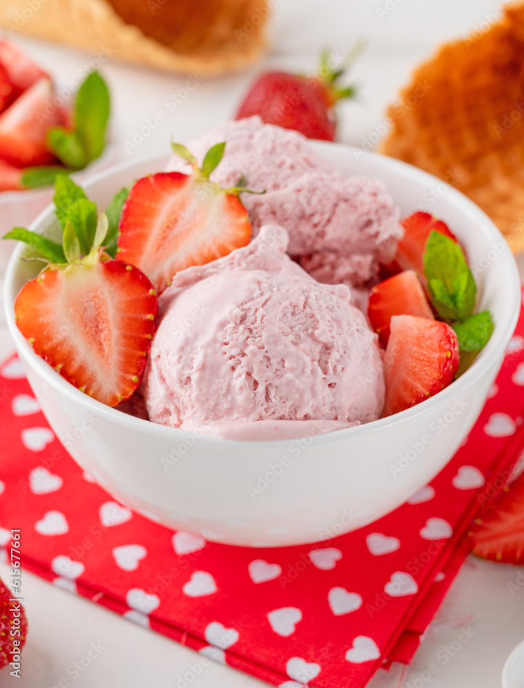 Strawberry ice cream with fresh berries in a bowl on a white wooden background. Selective focus Strawberry ice cream with fresh berries in a bowl on a white wooden background. Selective focus