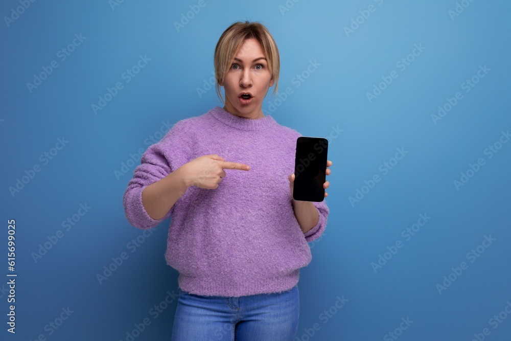 surprised blond young woman surprised holding smartphone mockup on bright colorful background surprised blond young woman surprised holding smartphone mockup on bright colorful background
