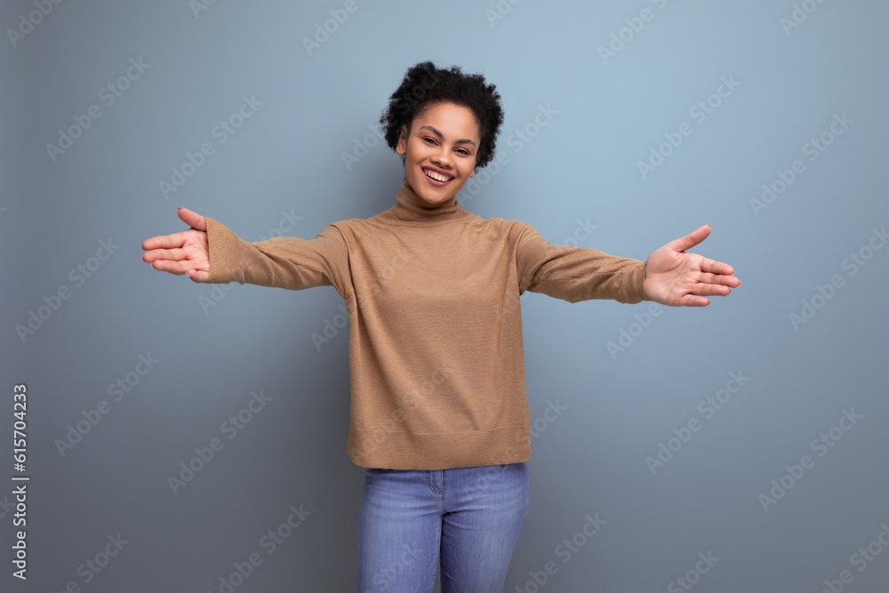 young woman with swarthy skin and fluffy hair with open arms over isolated background with copy space young woman with swarthy skin and fluffy hair with open arms over isolated background with copy space