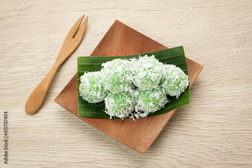 Klepon, Indonesian traditional snack, made from glutinous rice flour formed into small balls and filled with brown sugar. Finally covered with grated coconut.
 photo