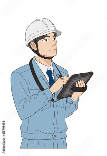 タブレットに入力する若手の現場監督