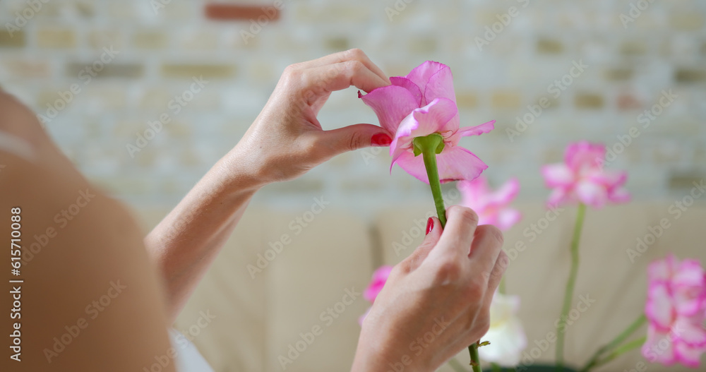 Young woman florist in floral shop preparing bunch from roses Young woman florist in floral shop preparing bunch from roses