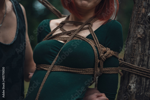 breast of beautiful redhead woman in green body tied with shibari rope Kinbaku japanese bandage