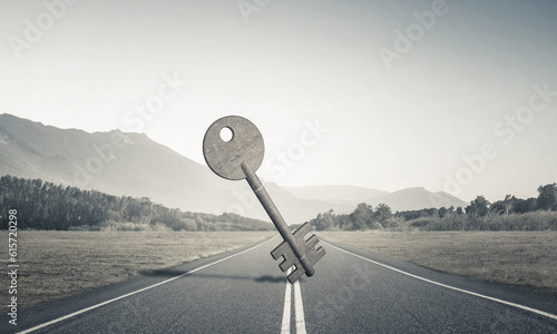 Conceptual background image of concrete key sign on asphalt road