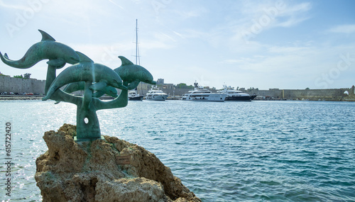 Fototapeta Naklejka Na Ścianę i Meble -  View of the Delphinia Sculpture and the old town bay near Rhodes Old Town, Rhodes, Greece