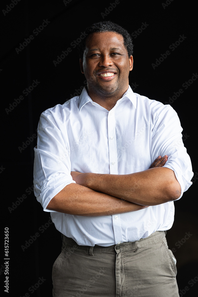 Portrait of handsome black businessman smiling with arms crossed Portrait of handsome black businessman smiling with arms crossed