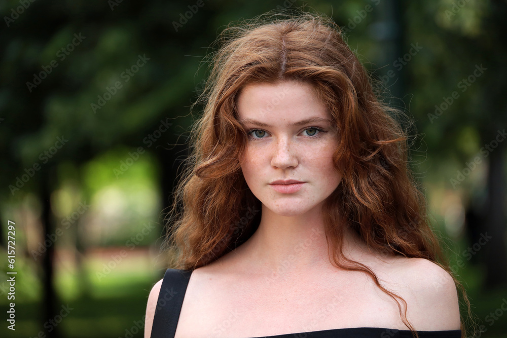 Sensual close up outdoor portrait of young ginger caucasian attractive girl with red hair and freckles in summer park, natural female beauty Sensual close up outdoor portrait of young ginger caucasian attractive girl with red hair and freckles in summer park, natural female beauty