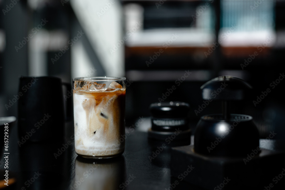 Iced coffee with ice cubes in a glass on the table Iced coffee with ice cubes in a glass on the table