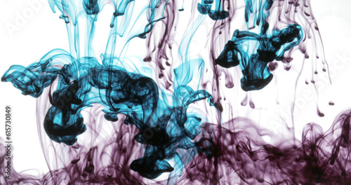 Movement of liquid black ink drops of blue and red