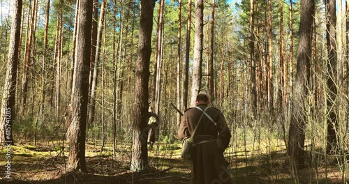 Re-enactors Dressed As Russian Soviet Infantry Red Army Soldiers Of World War II Marching Along Forest In Spring Autumn. Group of Soldiers Marching. photo