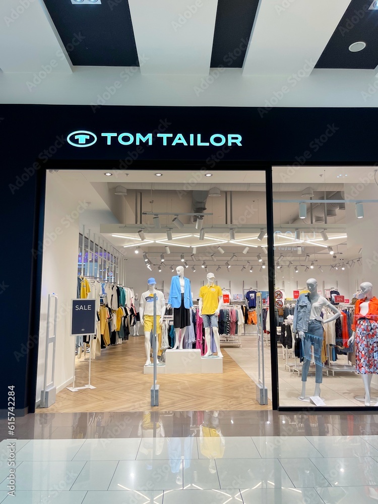 TOM TAILOR official store in shopping mall. Casual clothes for women, men,  kids. Brand shop in store department. TT trademark. German vertically  integrated lifestyle fashion company. New collection. Stock Photo | Adobe