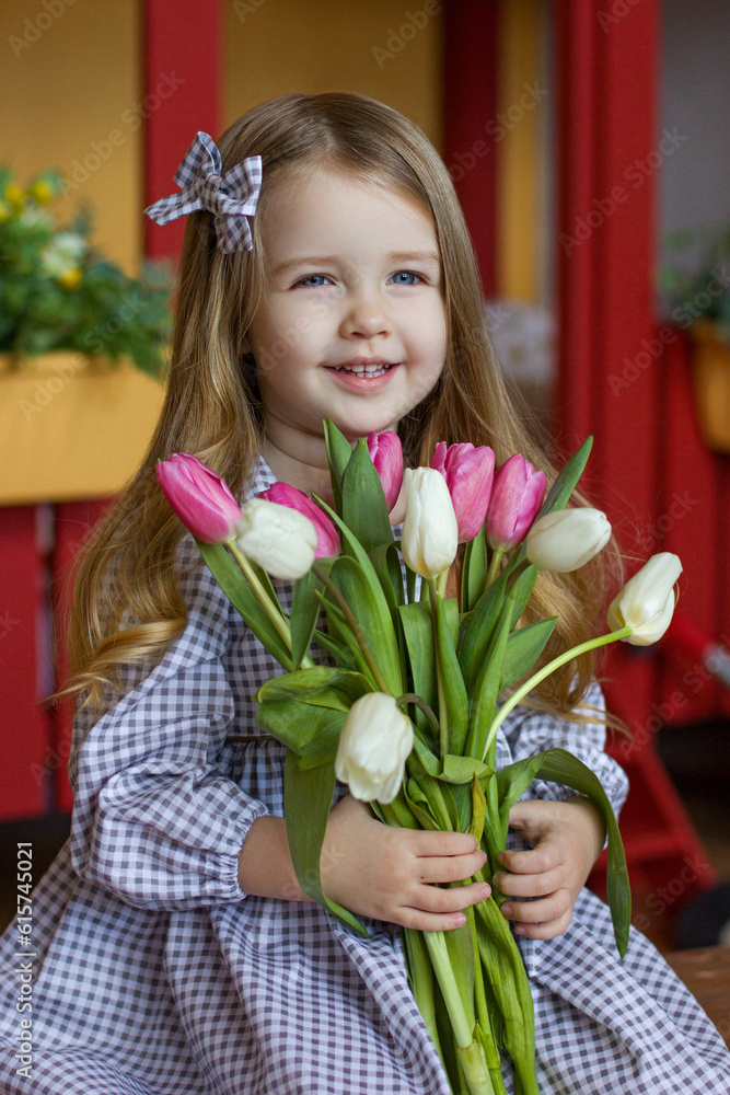 a girl in a dress with tulips in her hands a girl in a dress with tulips in her hands