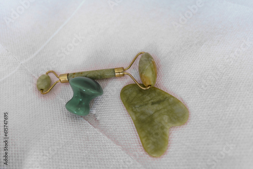 Close up of jade roller and gua sha for face massages and face lifting