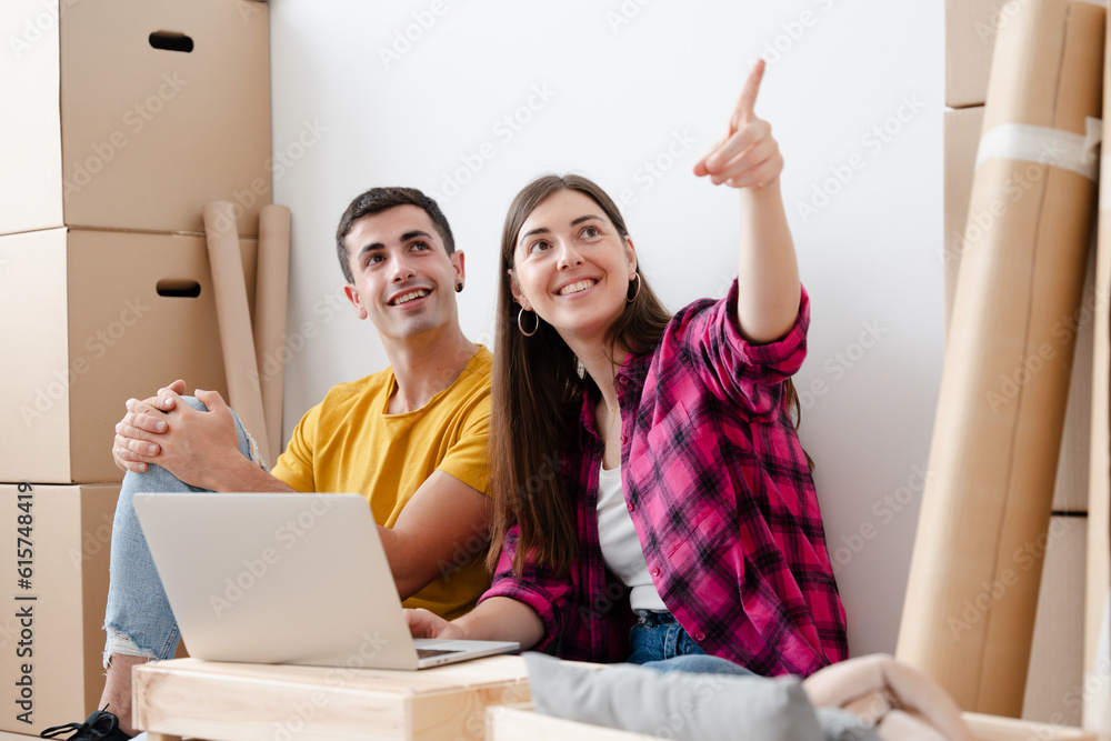 Happy young couple moving home Happy young couple moving home