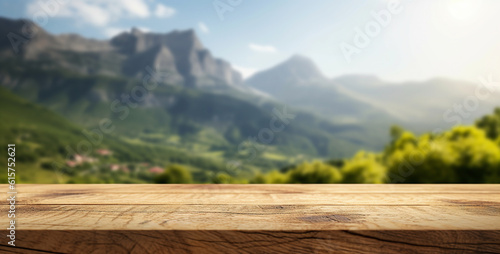 Empty wooden tabletop close-up against the backdrop of a mountain range.