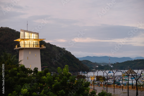 A beautiful white lighthouse against the sky in the port town of Labuan Bajo, Indonesia.