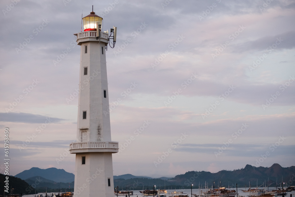 A beautiful white lighthouse against the sky in the port town of Labuan Bajo, Indonesia. A beautiful white lighthouse against the sky in the port town of Labuan Bajo, Indonesia.