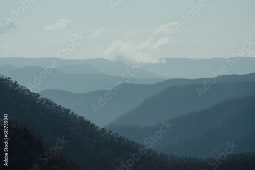 Blue mountain layers through the valley at Kanangra Walls Lookout on a sunny day