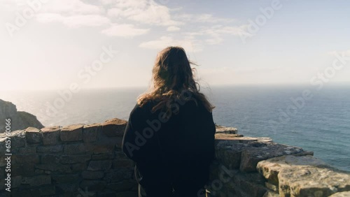 Young woman looking on to ocean at cape point national park