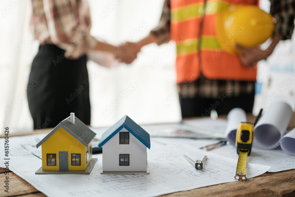 Close-up image of an engineer shaking hands with his coworker during the meeting. teamwork, building trust, unity Close-up image of an engineer shaking hands with his coworker during the meeting. teamwork, building trust, unity