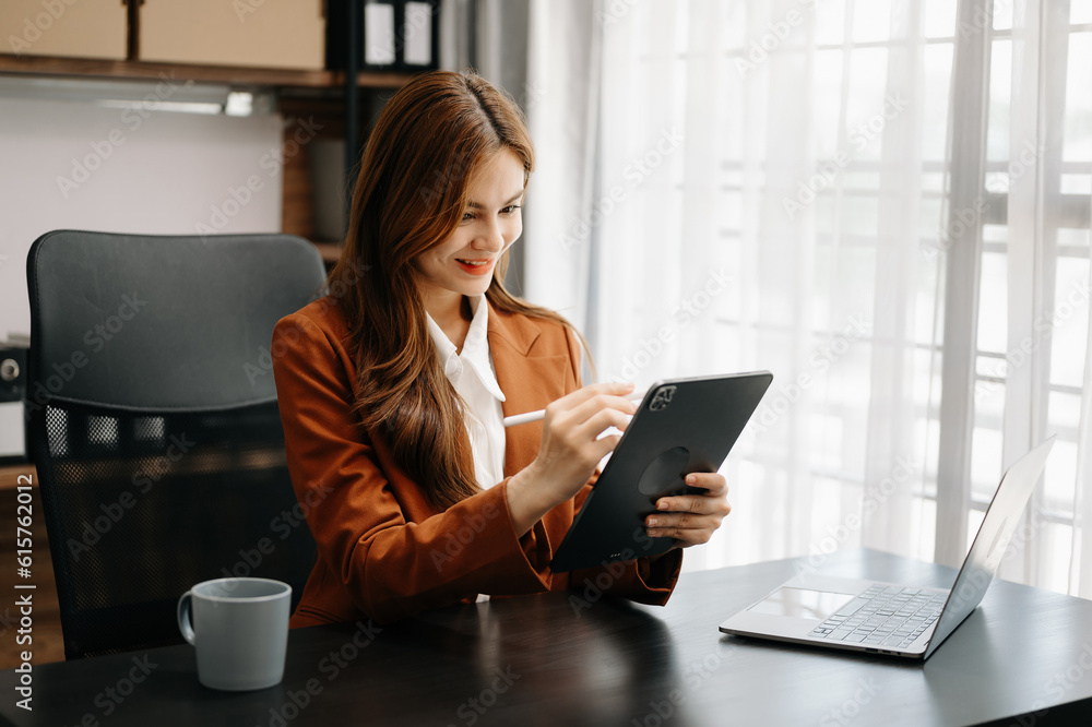 Confident business expert attractive smiling young woman holding digital tablet on desk in creative office. Confident business expert attractive smiling young woman holding digital tablet on desk in creative office.