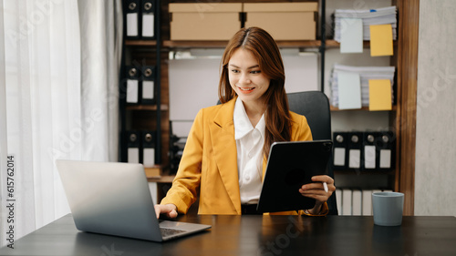 Confident business expert attractive smiling young woman holding digital tablet on desk in creative office.