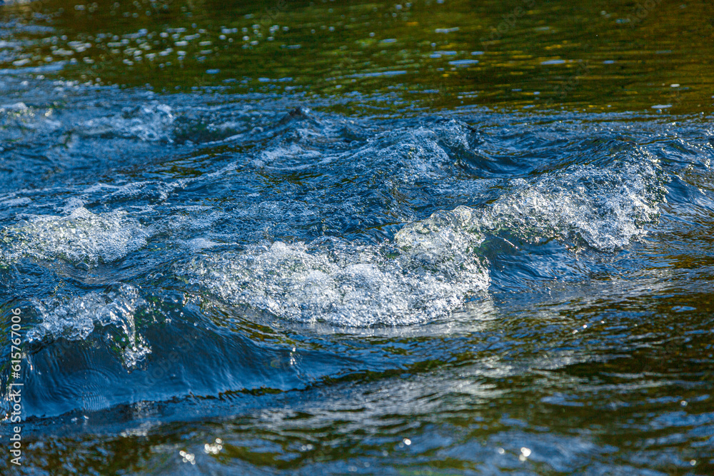 flow of water and spray from a stone flow of water and spray from a stone