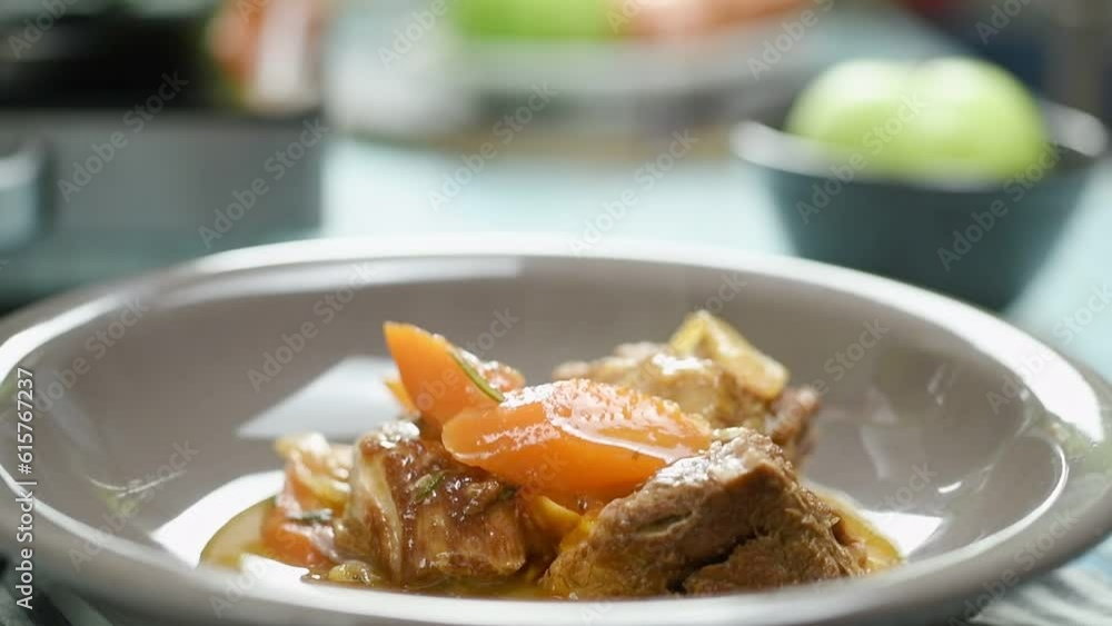 Pouring sauce over the braised pork shoulder, served on the plate.
Pouring sauce over the braised pork shoulder, served on the plate.