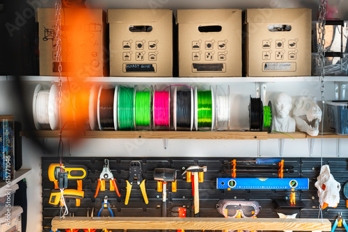 Home studio, garage tools. Organized items in a home workshop. Tool wall. 3D print elements, filaments and boxes. Creative place wall.  photo