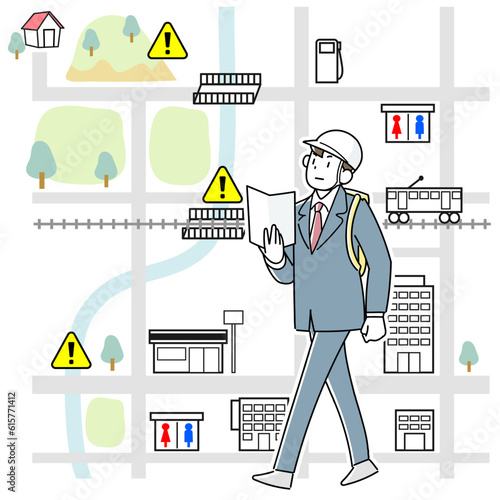 災害時にマップを手に職場から徒歩で帰宅している若い男性